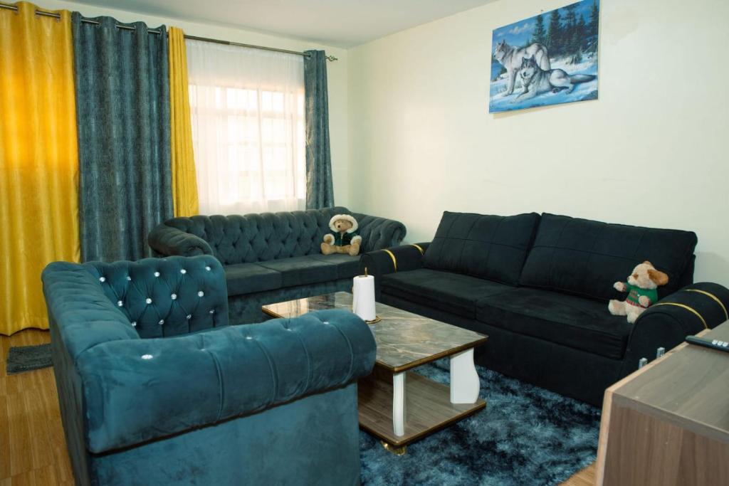 a living room with two couches and a table at Micasa Homes BNB D2 in Limuru