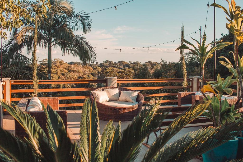 a resort with a hammock on a deck with palm trees at Hotel Sonnet Curitiba in Curitiba