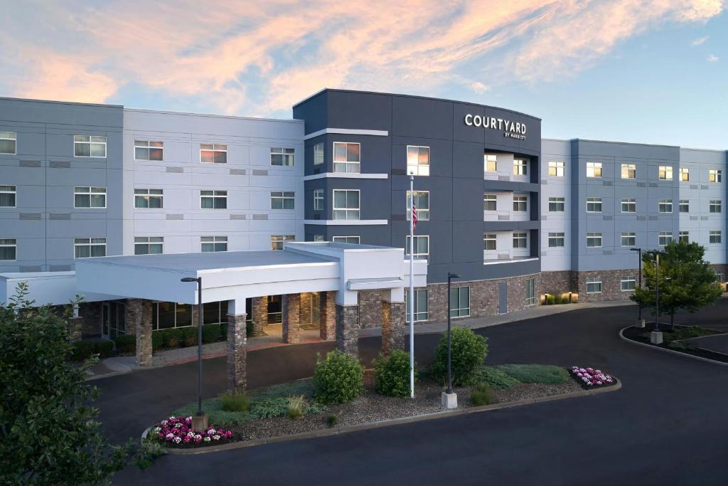 a rendering of a building with a court yard at Courtyard by Marriott Schenectady at Mohawk Harbor in Schenectady