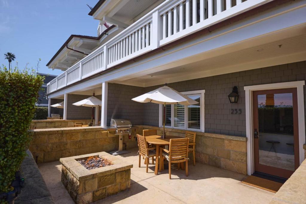 a patio with a table and chairs and an umbrella at Playa One Bedroom (255) in Carpinteria
