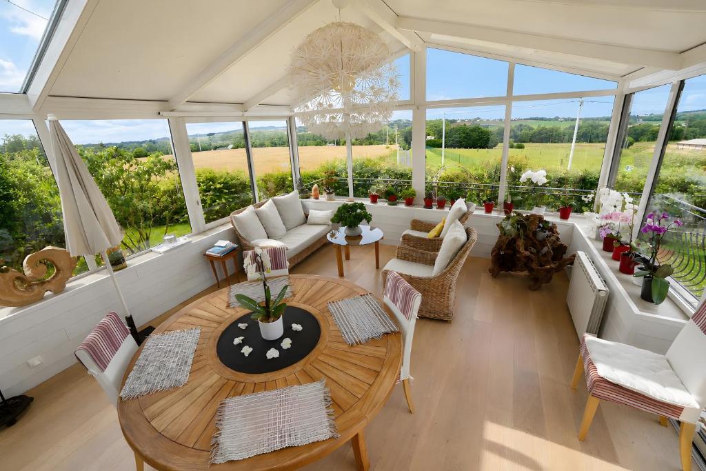 an aerial view of a living room with a table and chairs at Chambre d'hotes la Mainguy in Ruca