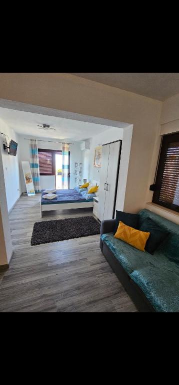 a living room with a couch and a bed at Villa Bravo in Podstrana