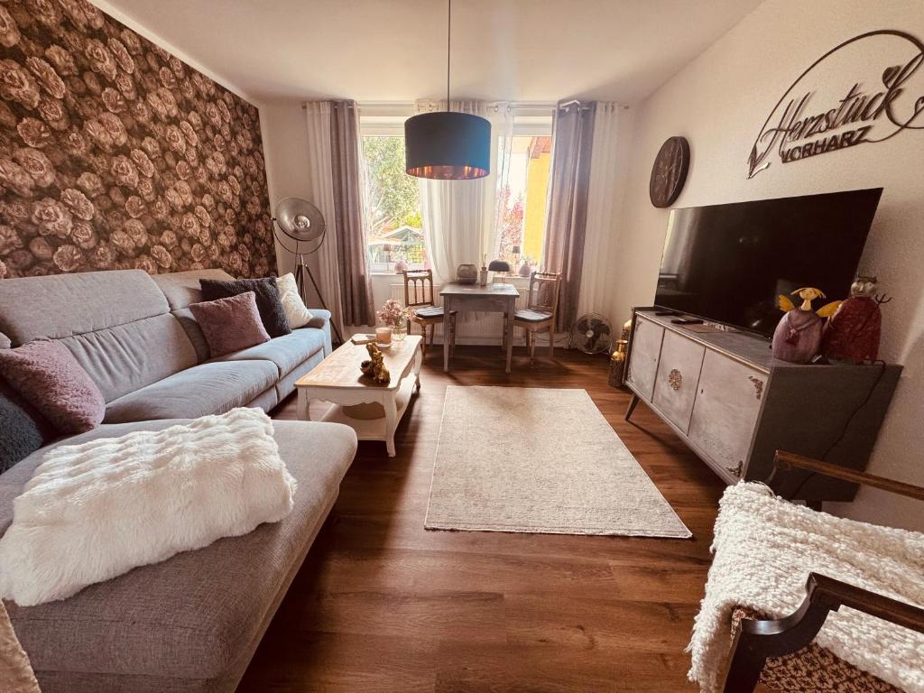 a living room with a couch and a tv at Herzstück in Schwanebeck