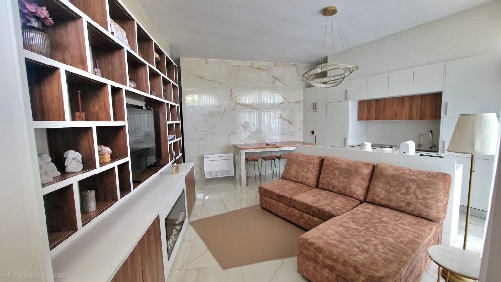 a living room with a couch and a kitchen at Cidadela do Viriato in Viseu