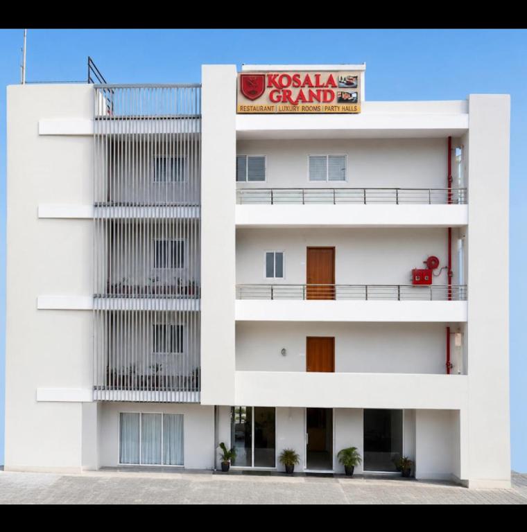 a white building with a sign on it at Kosala grand in Bhadrāchalam