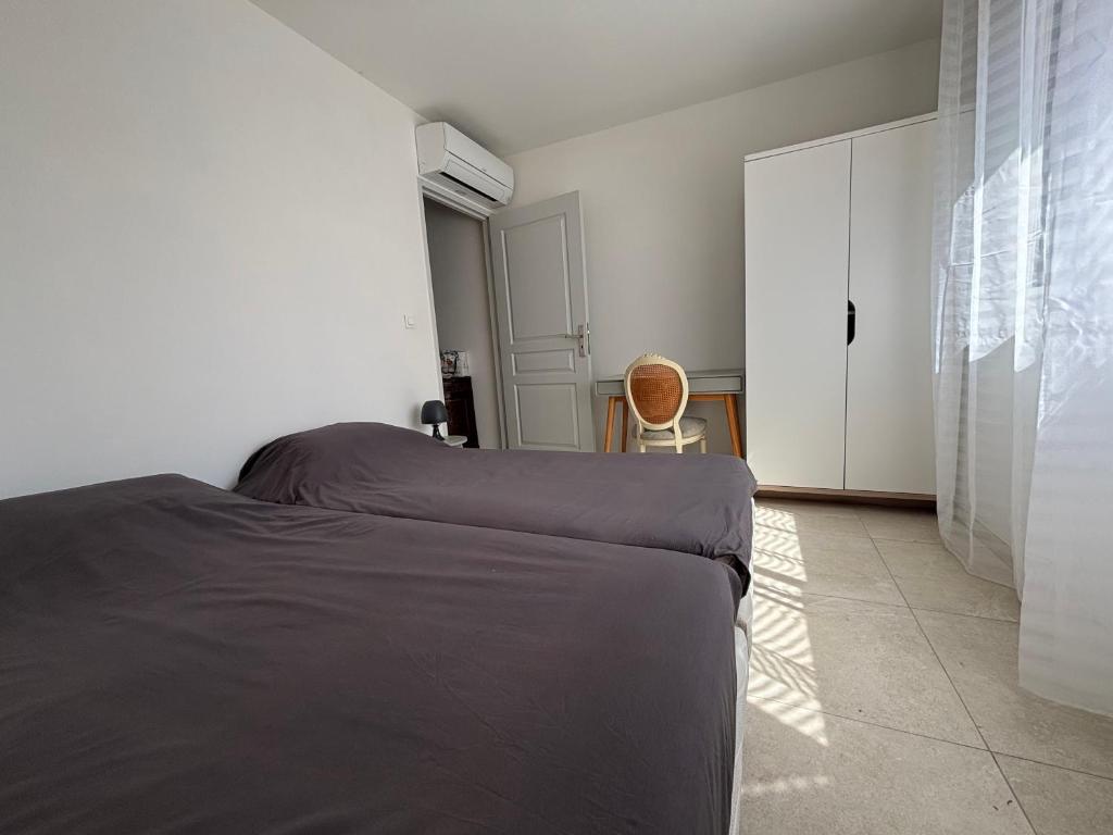 a bedroom with a bed and a closet and a chair at Casa Mezzana in Valle-di-Mezzana