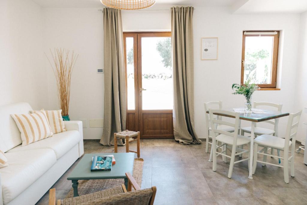 a living room with a couch and a table at Appartamento Sea - Tenuta Fascianello in Fasano