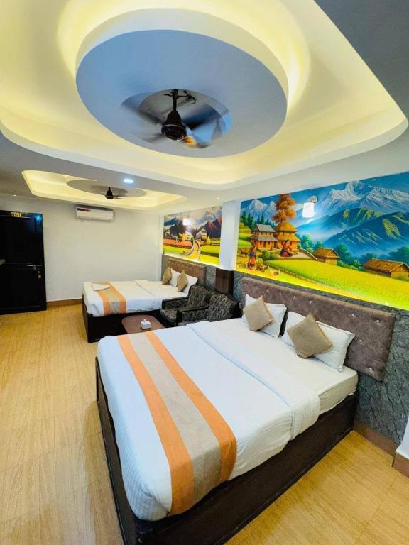 a hotel room with two beds and a painting on the wall at Hotel Delite in Thapathali