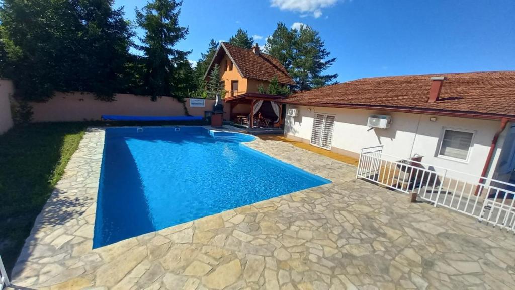 a swimming pool in the backyard of a house at Vila Ejna , Misevici in Rakovica