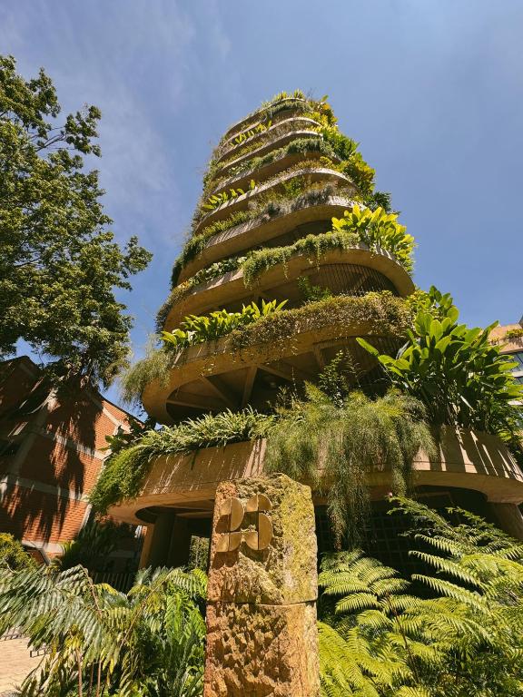 a building with plants on the side of it at 23 Living in Medellín