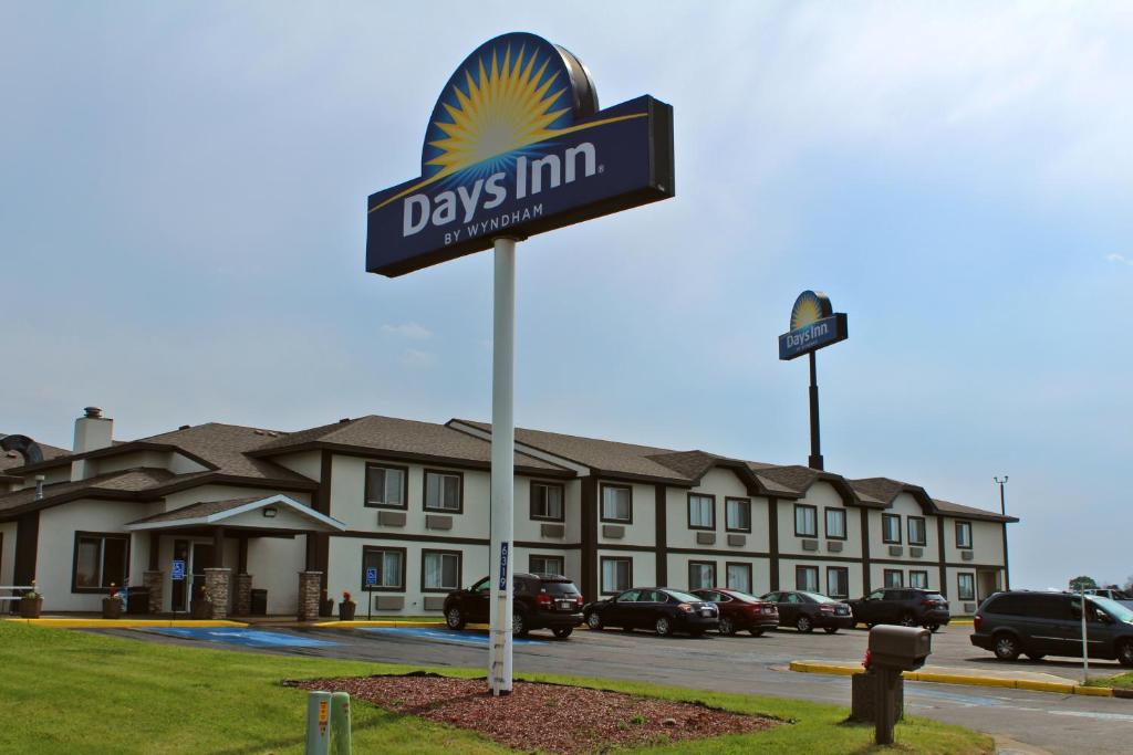 a days inn sign in front of a building at Days Inn by Wyndham West-Eau Claire in Eau Claire