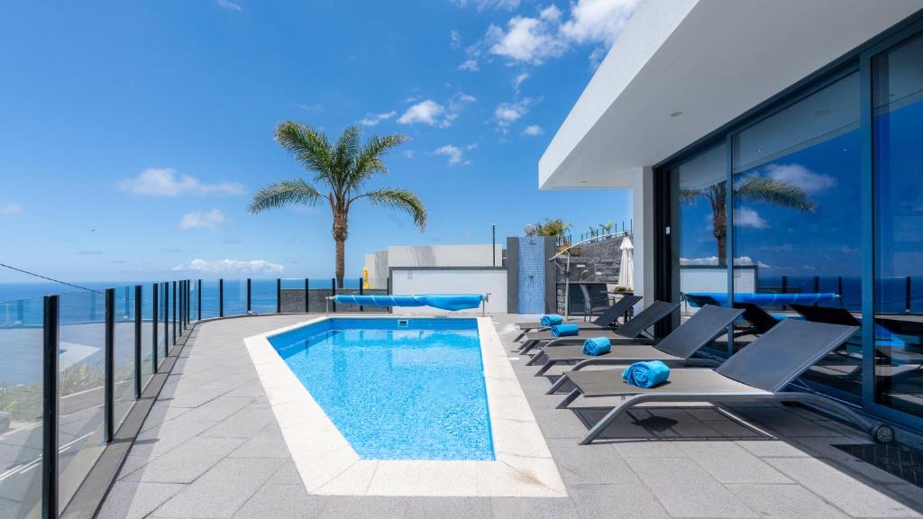 a swimming pool on the roof of a building at Villa Stella by LovelyStay in Arco da Calheta