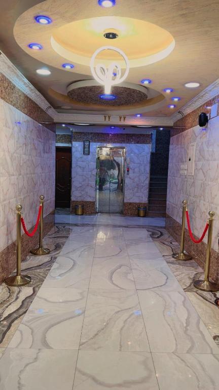 a large hall with a ceiling with a red ribbon at السلطان هاوس in Najran
