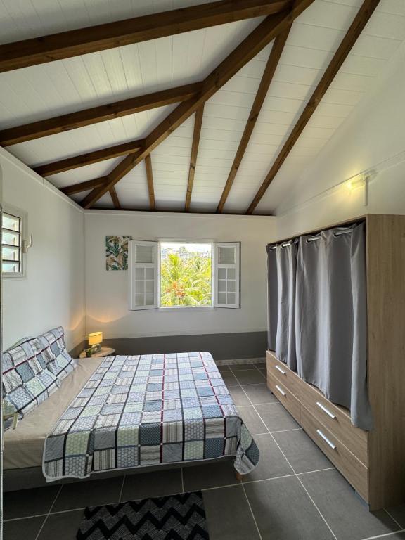 a bedroom with a bed and a window at Freedom House in Le Diamant
