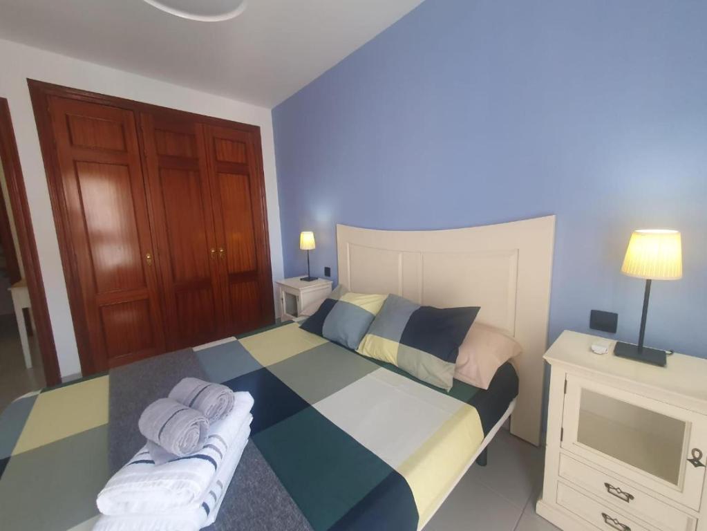 a bedroom with a bed with towels on it at Duplex Beach Cabezo 2h terrace in El Médano