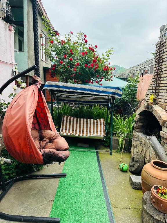 a patio with a hammock and a bench in a yard at Lovely Goris in Goris