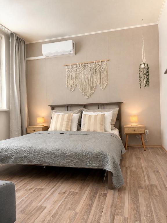 a bedroom with a large bed and two night stands at Apartmán Větrná s klimatizací a terasou in Zlín