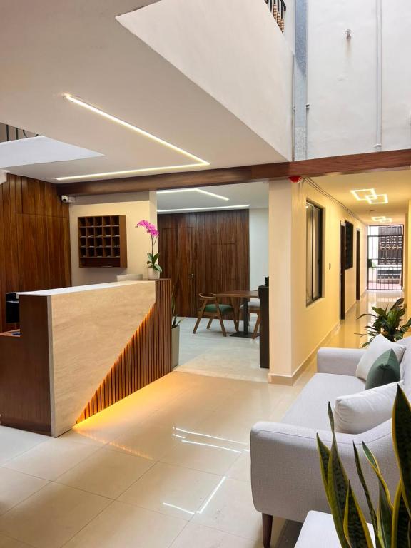 an office lobby with a reception desk and a table at Casa Herrerías Hotel & Confort in Cuenca