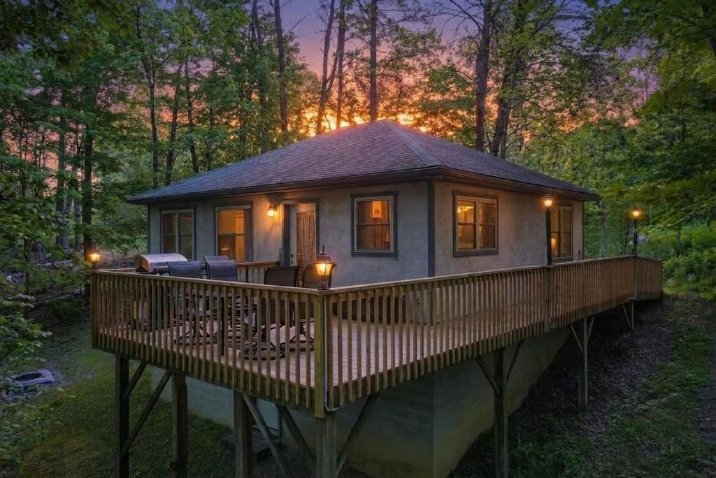 a small house on a deck in the woods at Honey Ridge Forest Retreat in South Bloomingville