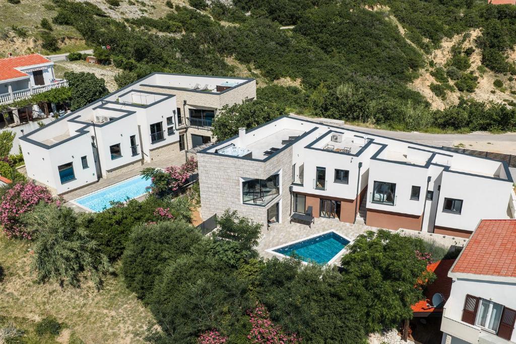 an aerial view of a house with a swimming pool at Villa Perla Nera & Villa Nevera by Pag tours in Stan Trigraci