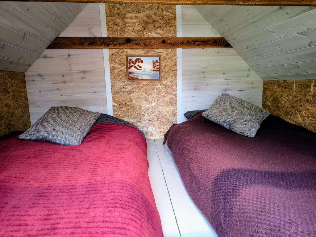 a bedroom with two beds in a attic at Sauna Suite 2 in Valga