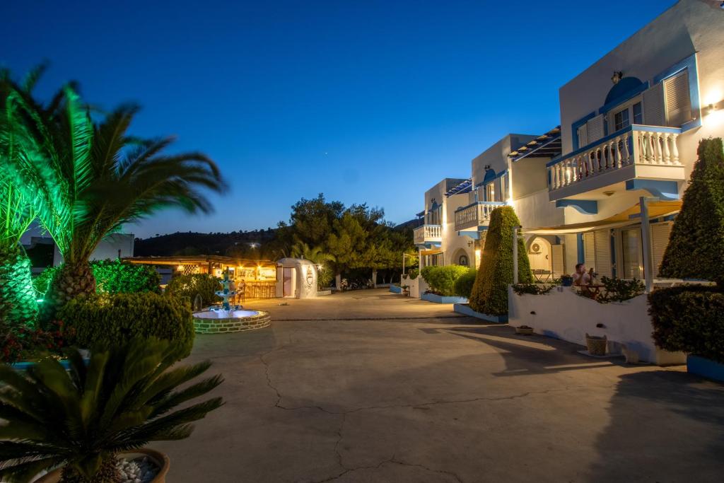 a villa with a courtyard at night at Elpiniki in Alinda