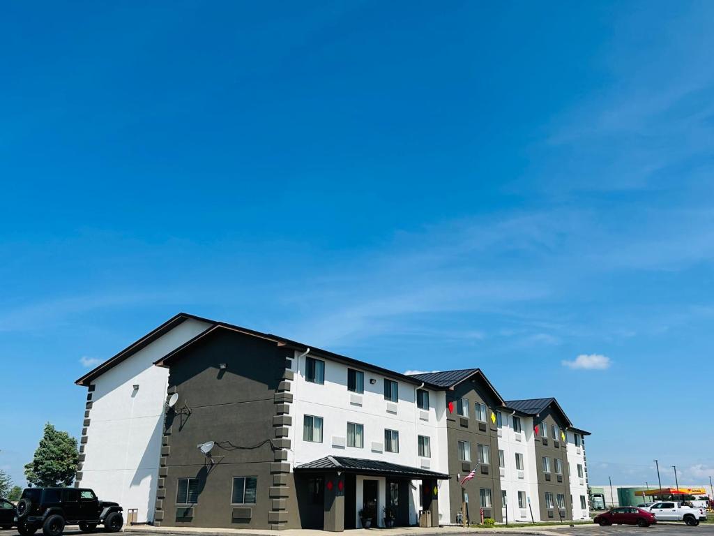 a large white building with a black roof at Super 8 by Wyndham Sioux City South in Sioux City