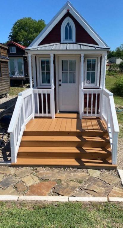 a house with a wooden deck with a white door at Casa Rosa Unit C on Lake Conroe in Willis