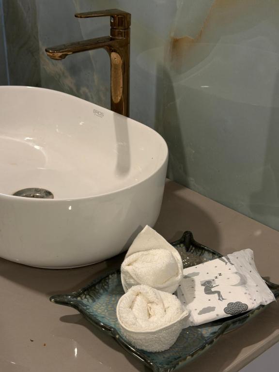 a bathroom counter with a sink and a plate with towels at Vanvaas the forest note in Godarpura