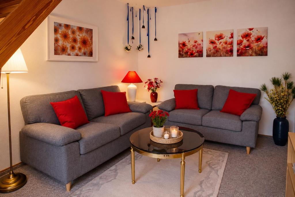 a living room with two couches and a table at Glaeßer Appartements in Burg auf Fehmarn