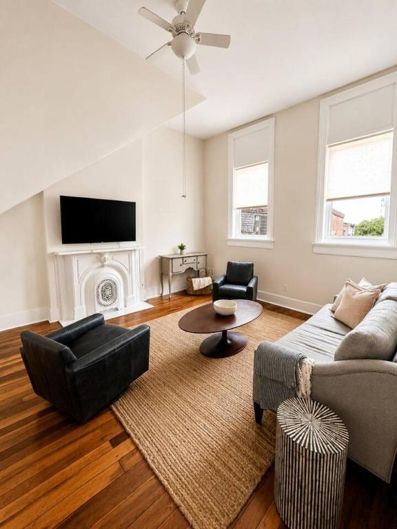 a living room with a couch and a table at Main Street Stay in Georgetown
