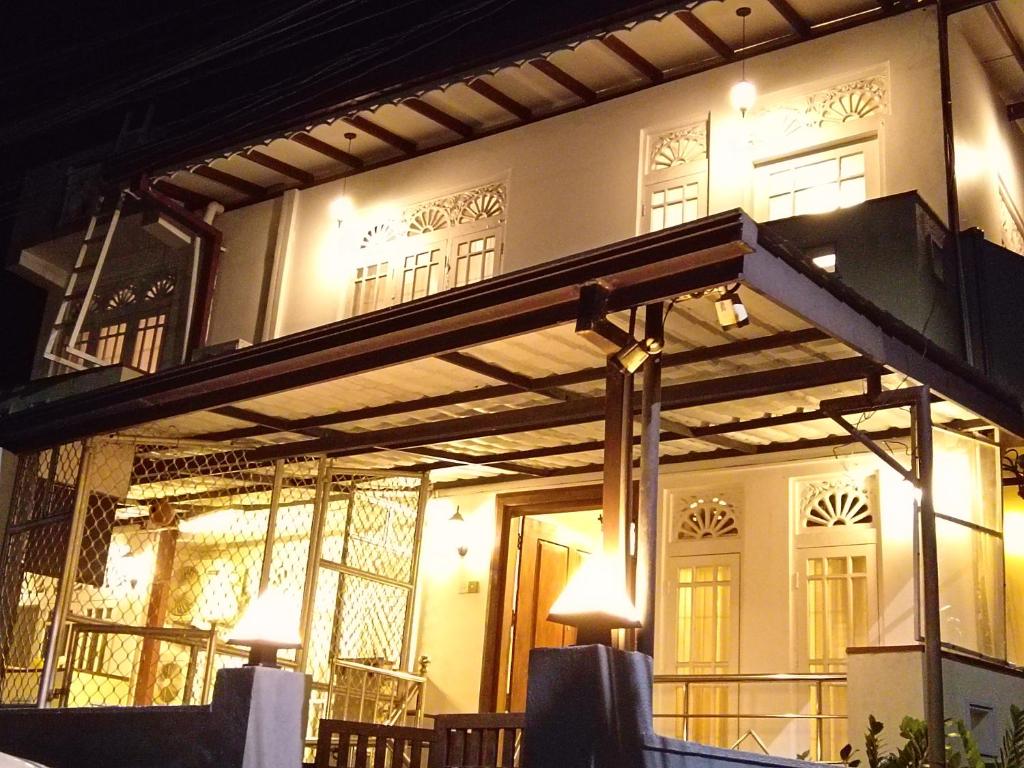 a building with a balcony with lights on it at Sobasee Holiday Bungalow in Kandy