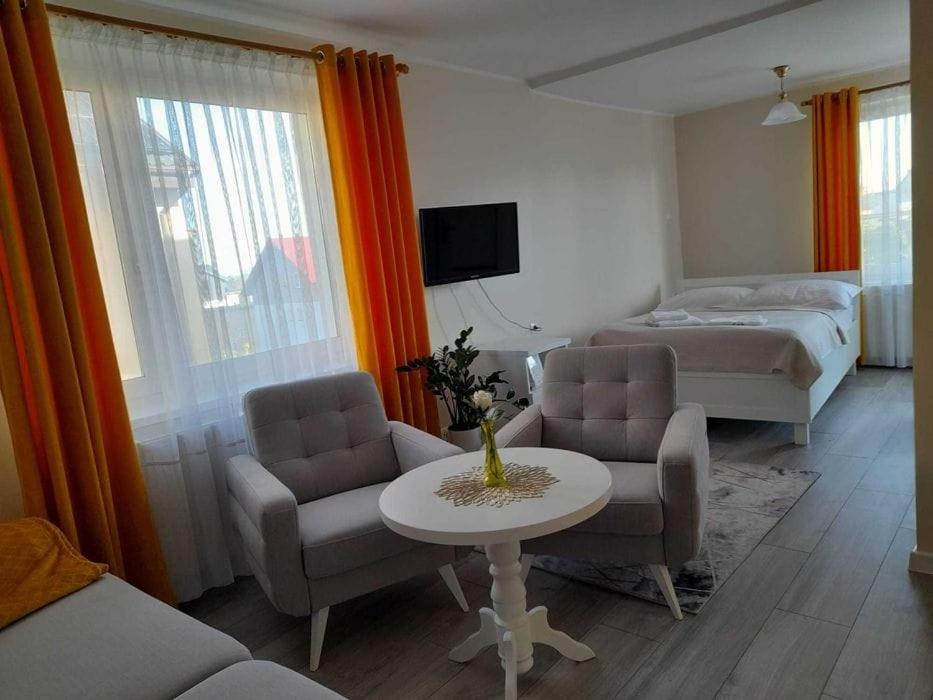 a hotel room with a bed and a table and chairs at Mirato in Władysławowo