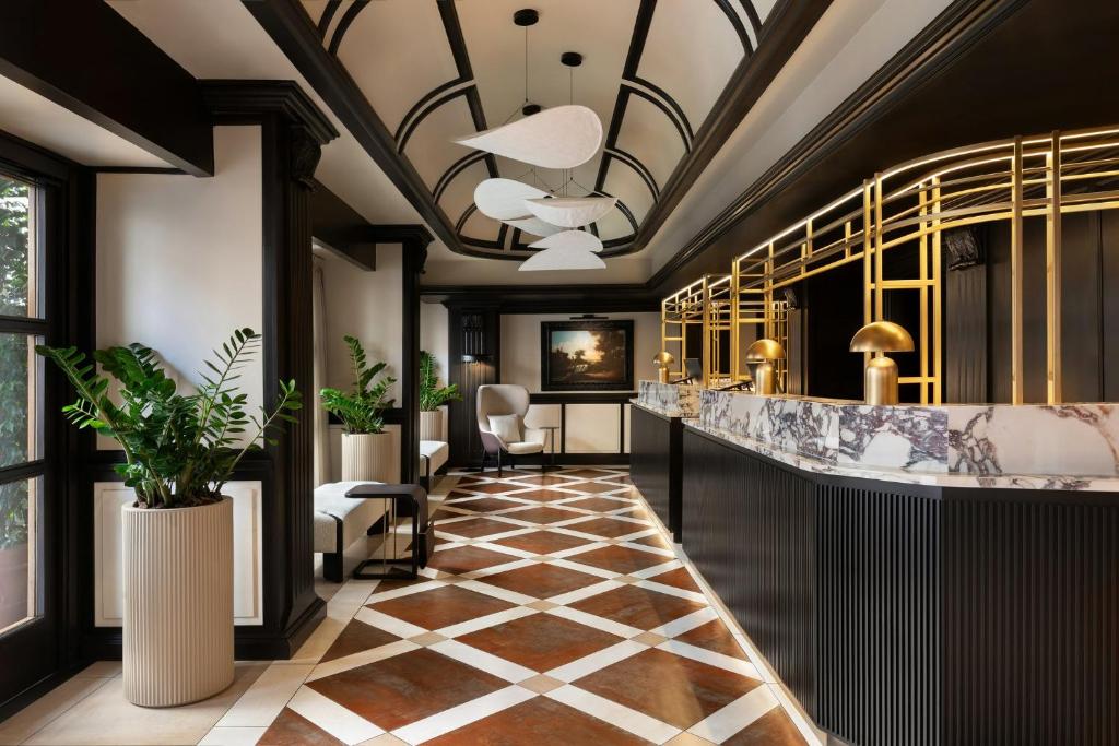 a lobby with a bar in a building at Sina De La Ville in Milan