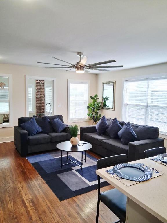 a living room with a couch and a table at Xscapecation Oasis III in Tulsa