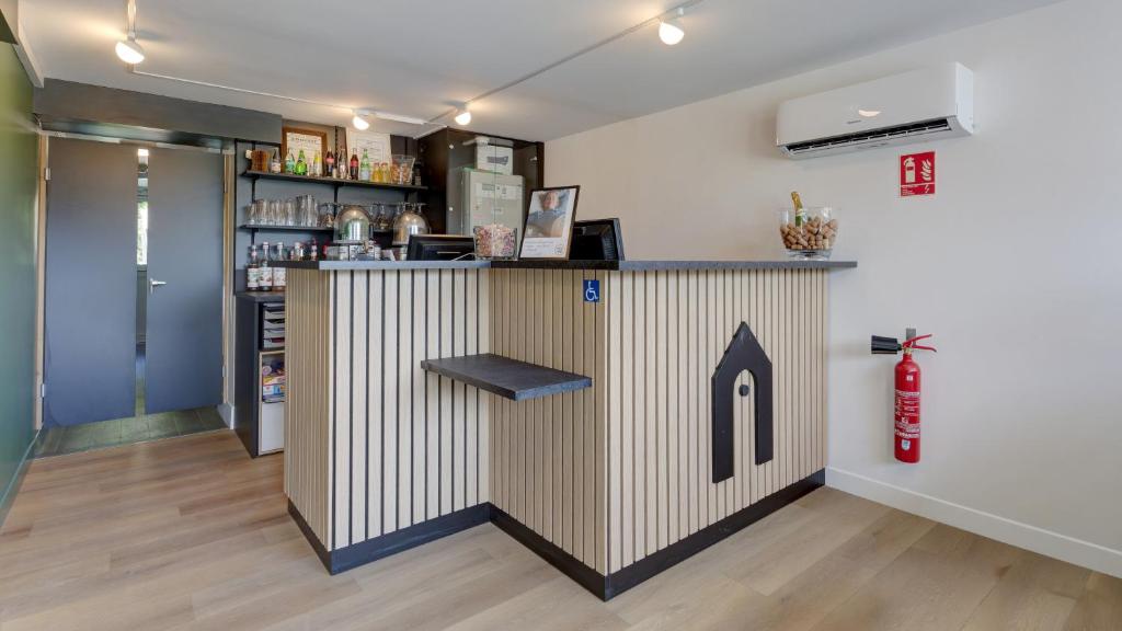 a bar with a building on the wall at Campanile Epernay - Dizy 51530 in Épernay