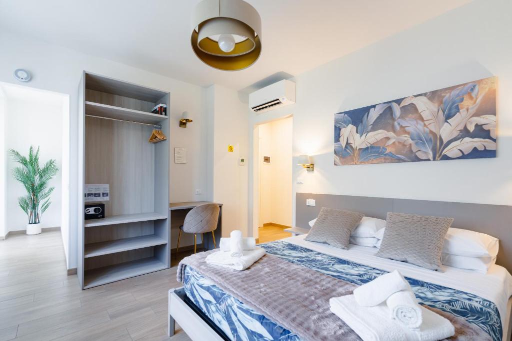 a bedroom with a large bed with towels on it at Madame Bologna in Bologna