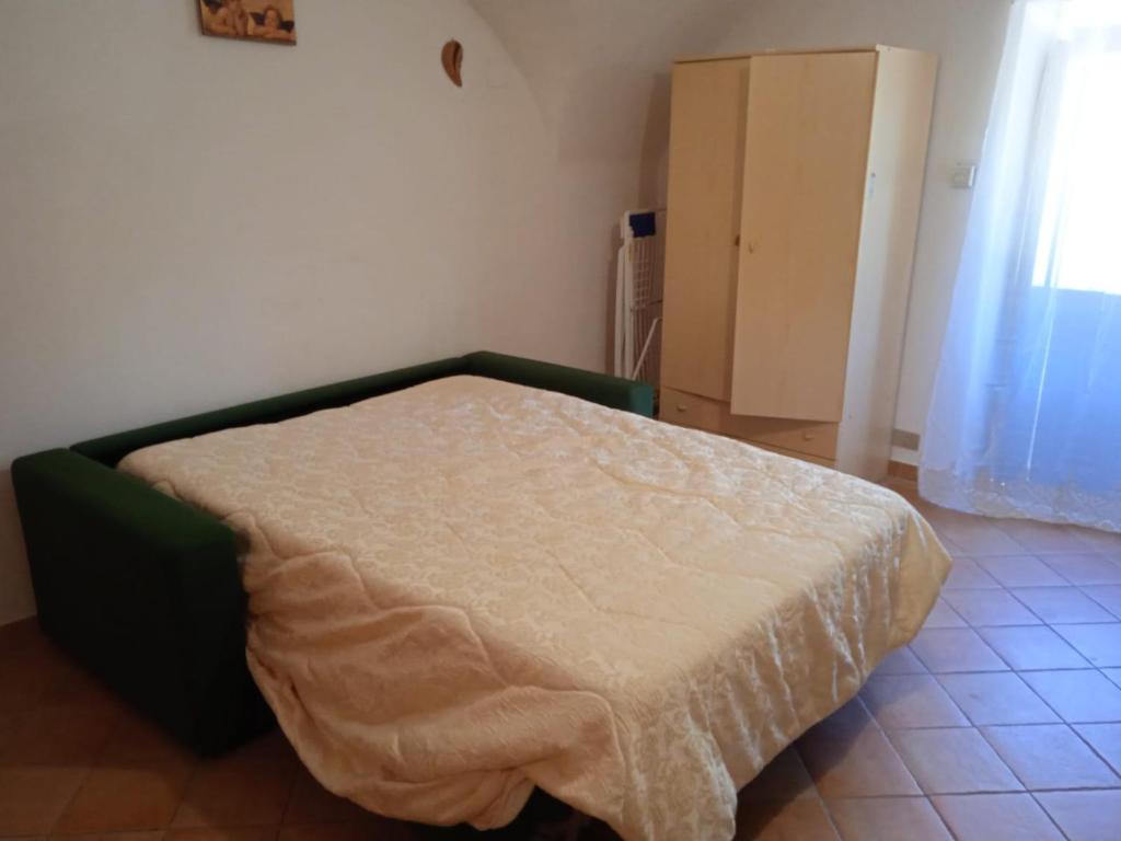 a bedroom with a bed with a blanket on it at Casa Vacanza da Luigi in Opi