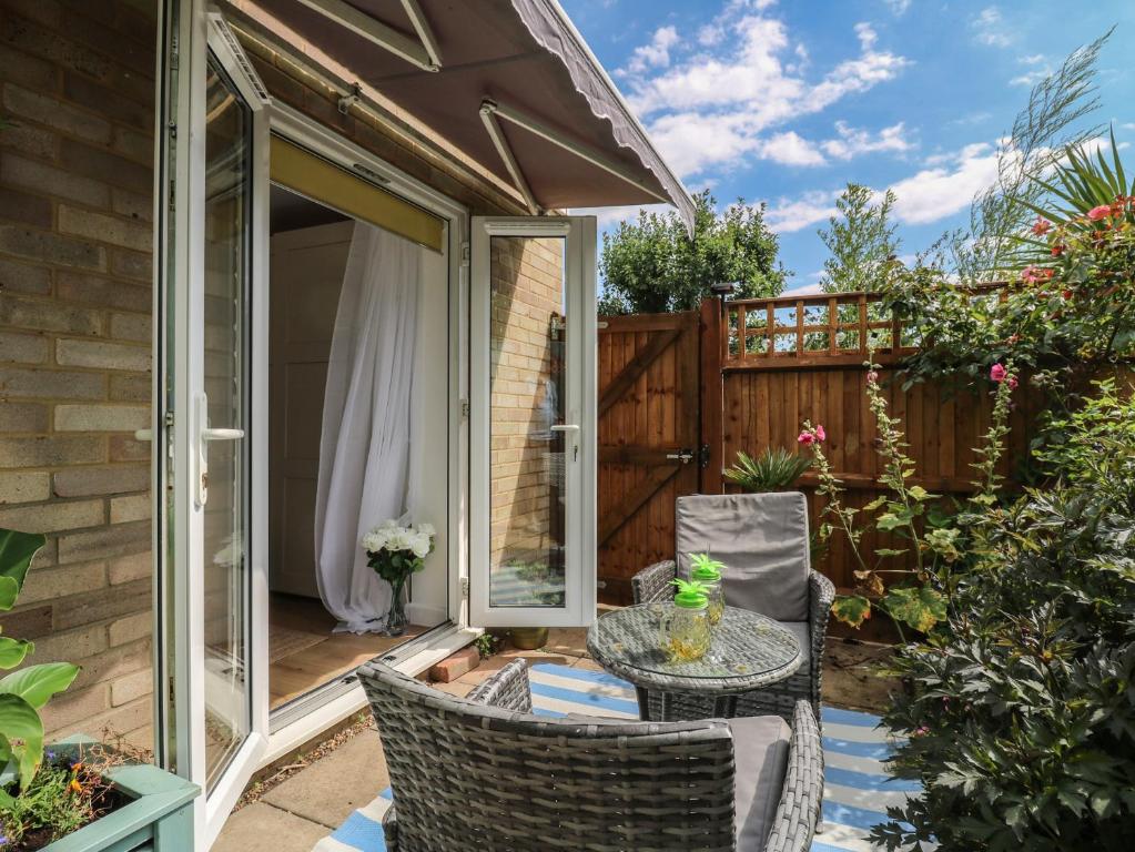a patio with a table and chairs at Oakwood Annexe in Colchester