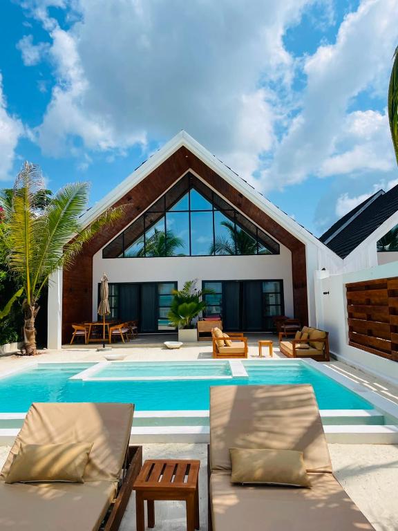 a villa with a swimming pool and a house at Solymar Villa 3 in Jambiani
