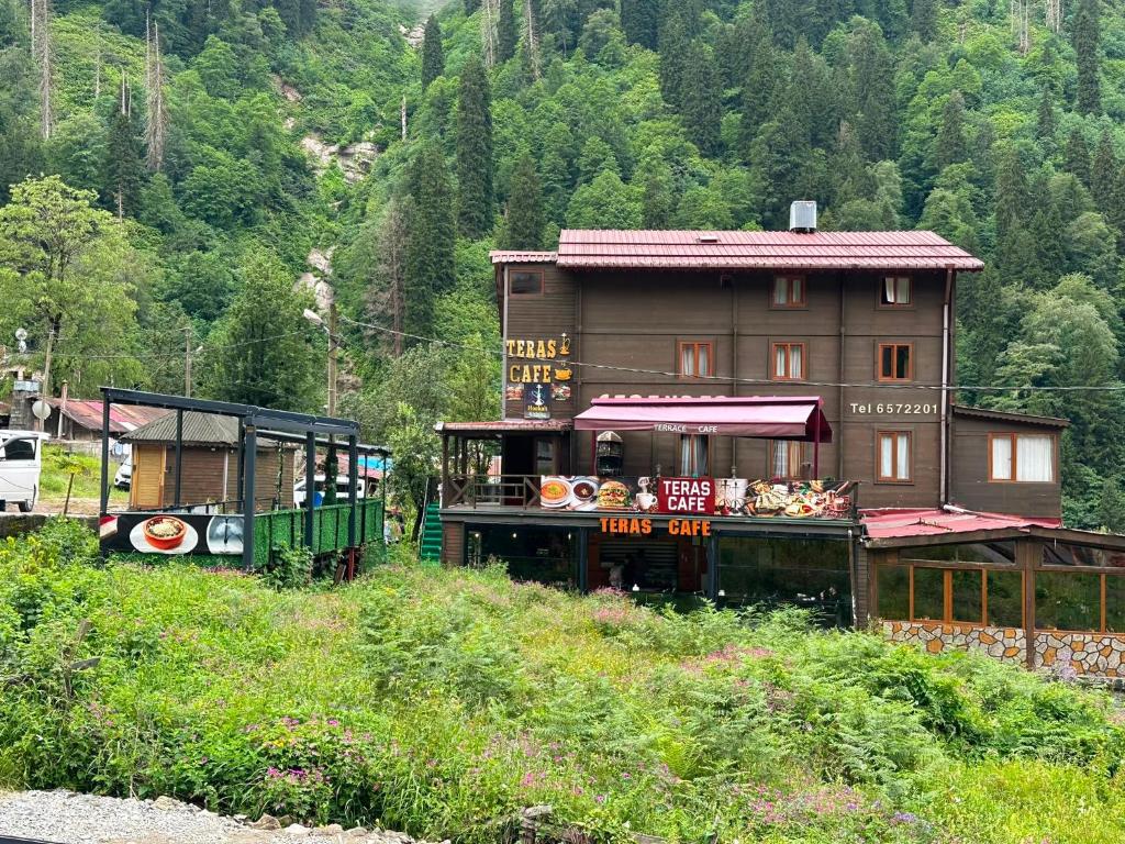 a small building with a food stand on a hill at Ayder Serender Otel in Çamlıhemşin