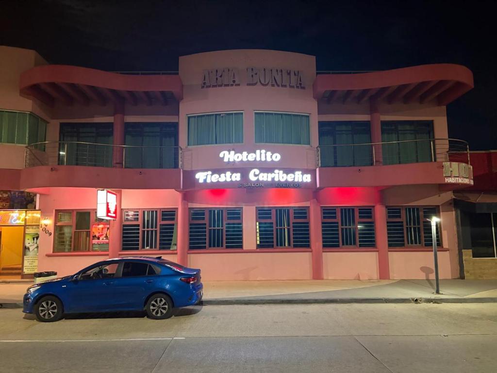 a blue car parked in front of a building at Hotelito Fiesta Caribena in Coatzacoalcos