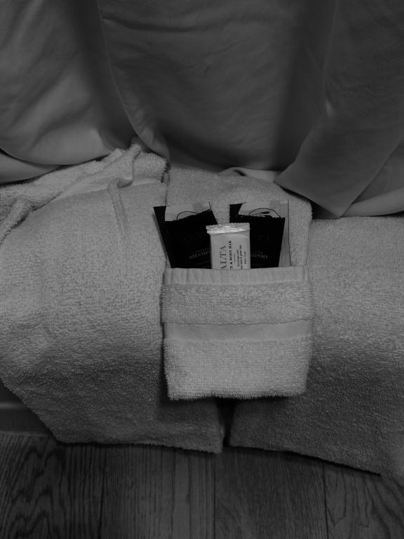 a pile of towels sitting on top of a bed at Heritage Inn in Fairview
