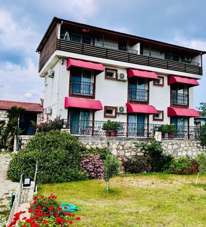 a large building with red awnings on it at Satsuma Butik Otel in Seferihisar
