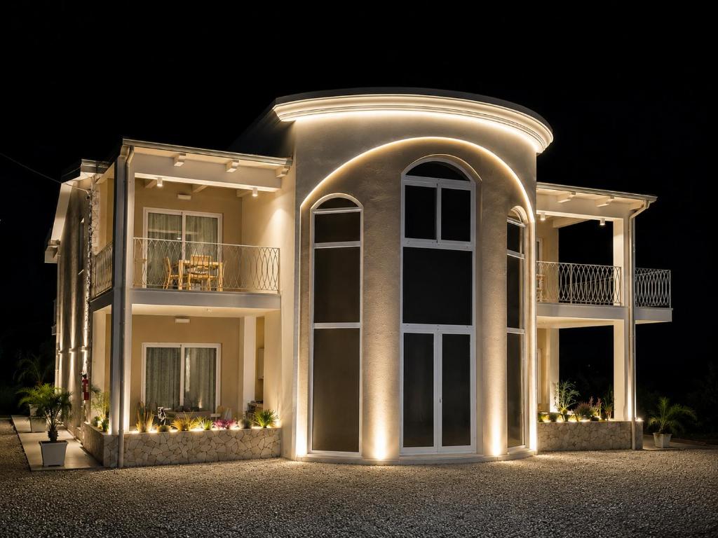 a large white house with lights on it at night at Villa Elysia Tropea in Tropea