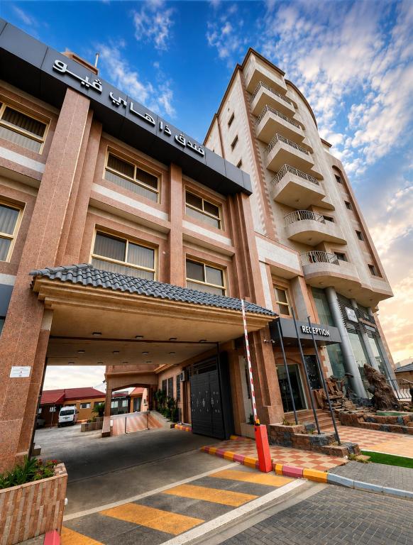 a building with a parking garage in front of it at The High View Hotel - ذا هاي فيو in Al Baha
