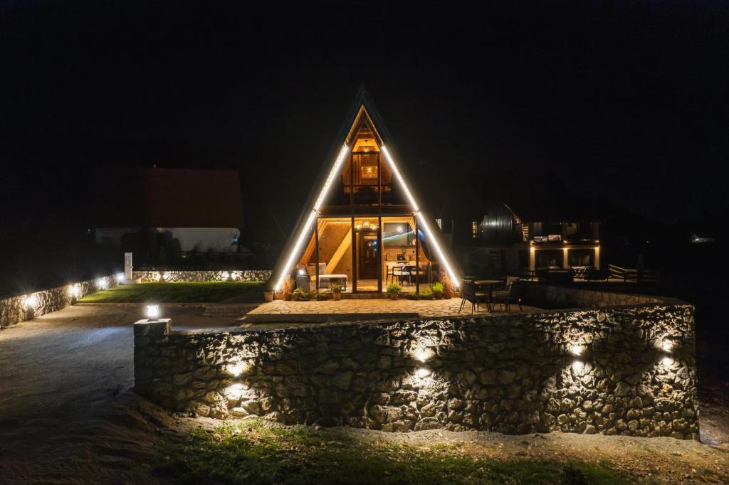a church lit up at night with lights at Falcon View Zabljak in Žabljak