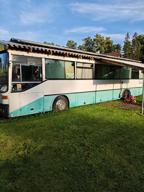 an old bus parked in a grass field at Glampingbus in Kärdla