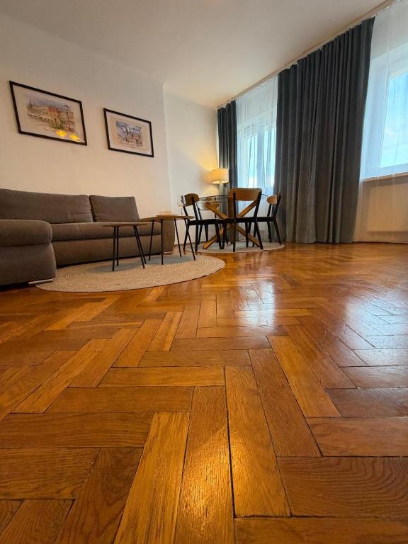 a living room with a couch and a table at Apartament Witosa in Tarnów