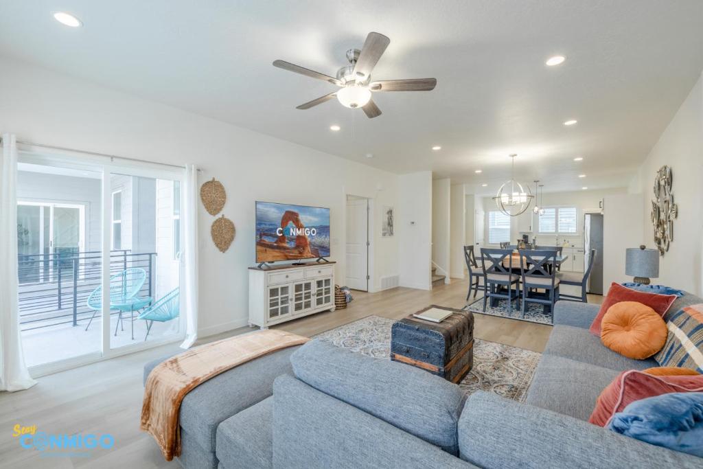 a living room with a couch and a ceiling fan at Pooley Pad in American Fork